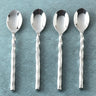 Four silver spoons with twisted handles on a textured blue background