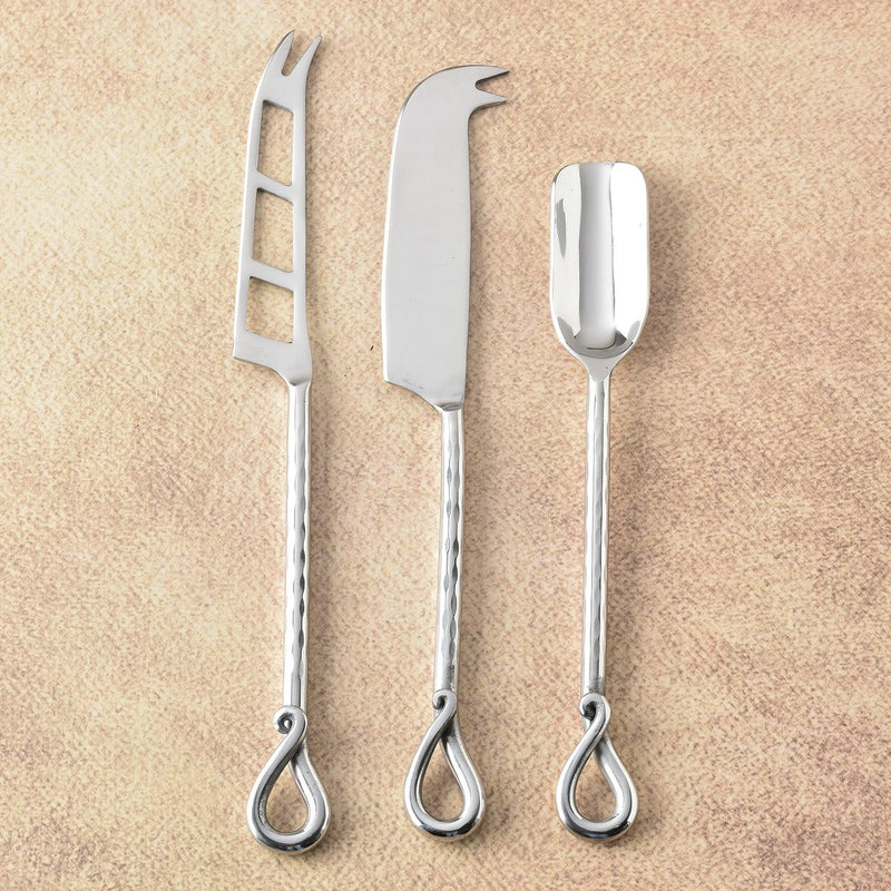 Stainless steel cheese tools for serving and slicing.
